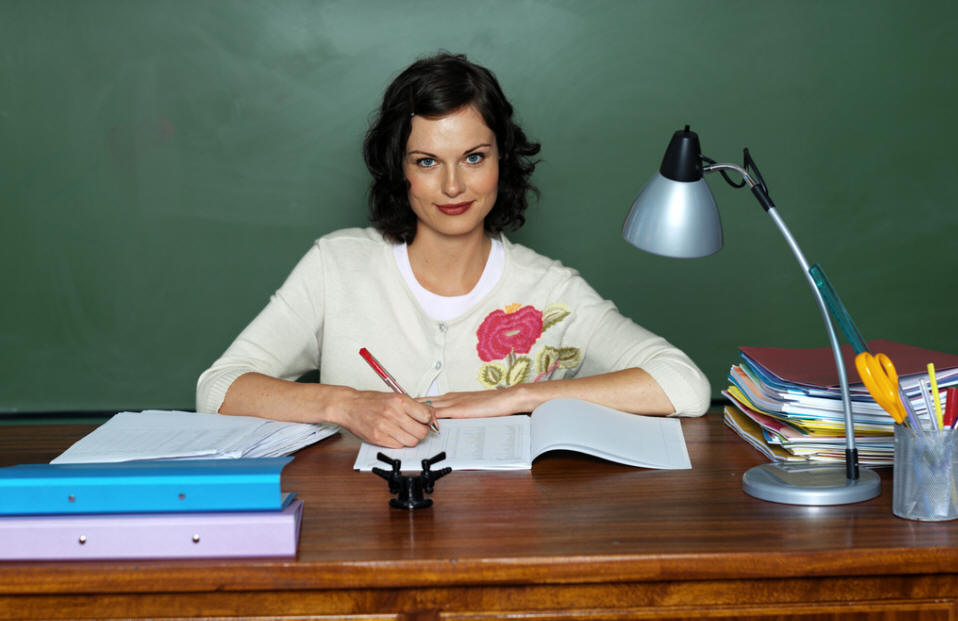 A Female Teacher sitting at her Desk